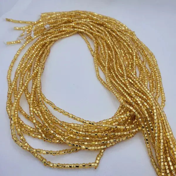 Gold beaded strands on a white background