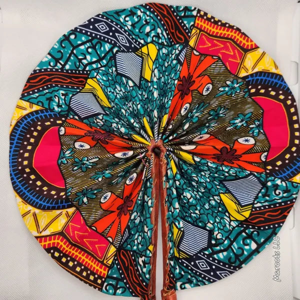 Colorful circular fabric design with intricate patterns on a white background